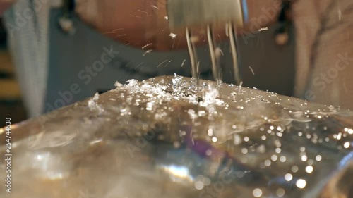 Barman is making brand ice for the cocktail at bar