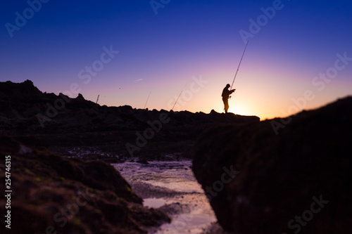 Fisherman fishing during beautiful sunset