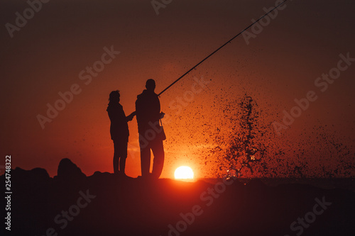 Couple fishing during beautiful and warm sunset © mehdivir