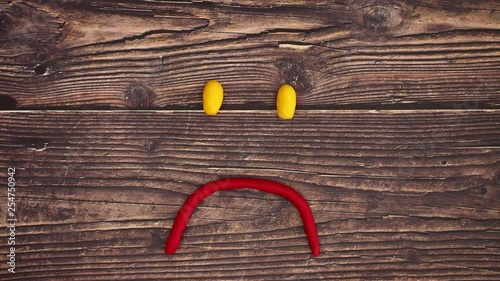 Play doh smiley on wooden table - Stop Motion photo