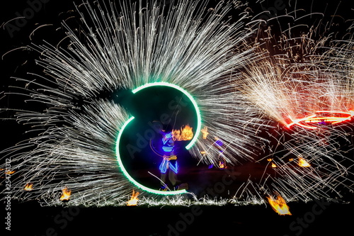 Amazing fire show dance. Fire dancers in beautiful costumes playing with flame