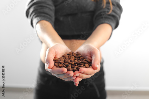coffee beans in hands on white background