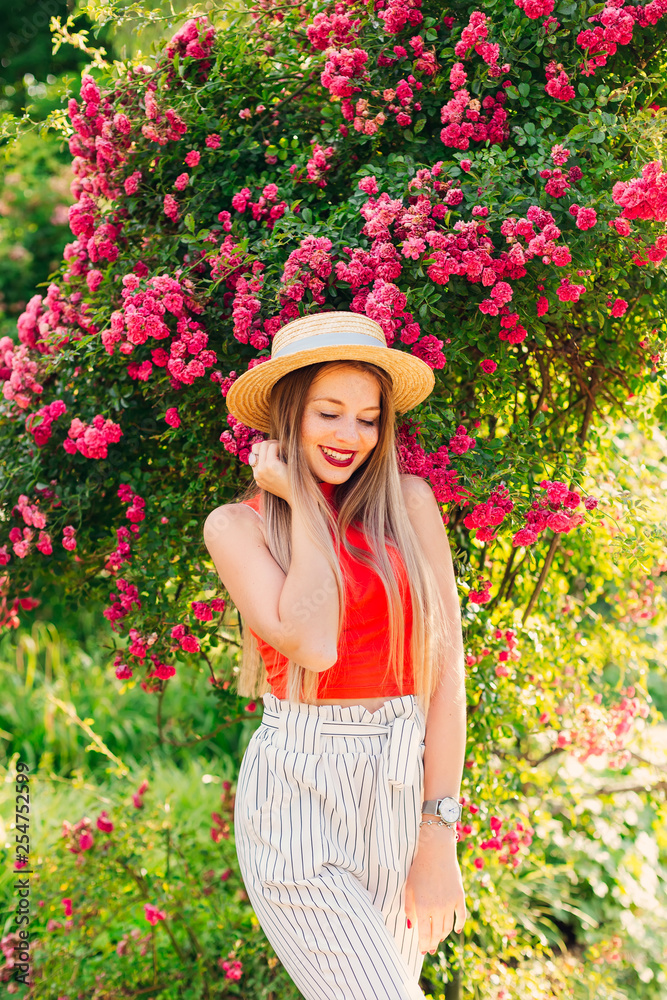 cute girl with boater closed her eyes and smile against the back