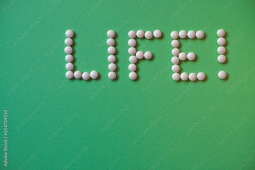 Medical topics. Tablets are laid out in an inscription for design and with a place for the text. Health, life. On a green background stock photography Medical topics. Tablets are laid out in an inscription for design and with a place for the text. Health, life. On a green background stock photography