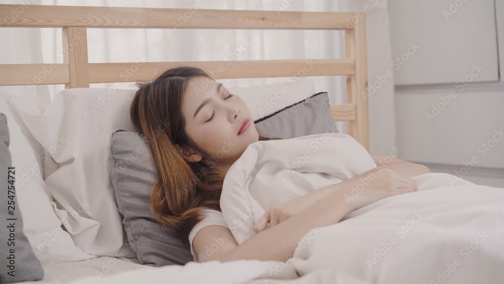 Asian woman dreaming while sleeping on bed in bedroom, Beautiful japanese female using relax time lying on bed at home. Lifestyle women using relax time at home concept. Asian woman dreaming while sleeping on bed in bedroom, Beautiful japanese female using relax time lying on bed at home. Lifestyle women using relax time at home concept.