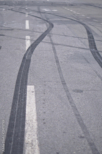 Abstract of Black tire wheels caused by Drift car on the road. Braking at a pedestrian crossing and a road with markings. Stock photo for design
