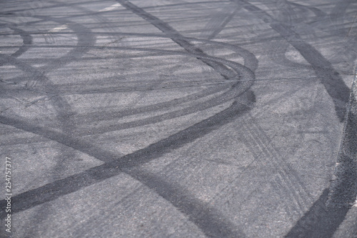 Abstract of Black tire wheels caused by Drift car on the road. Braking at a pedestrian crossing and a road with markings. Stock photo for design