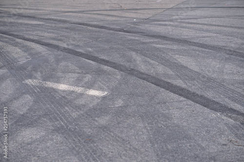 Abstract of Black tire wheels caused by Drift car on the road. Braking at a pedestrian crossing and a road with markings. Stock photo for design