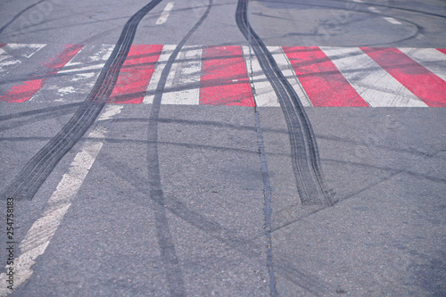 Abstract of Black tire wheels caused by Drift car on the road. Braking at a pedestrian crossing and a road with markings. Stock photo for design