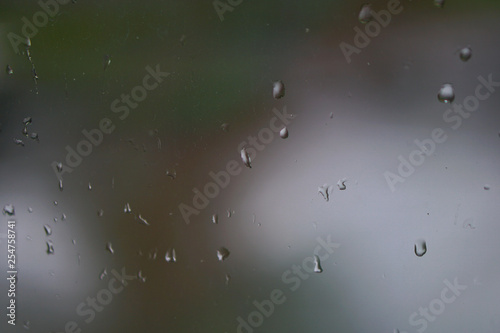 Fresh weather outside the window after the rain with drops on the window. rainy nature of autumn and summer days. Cool spring conditions. Stock photos