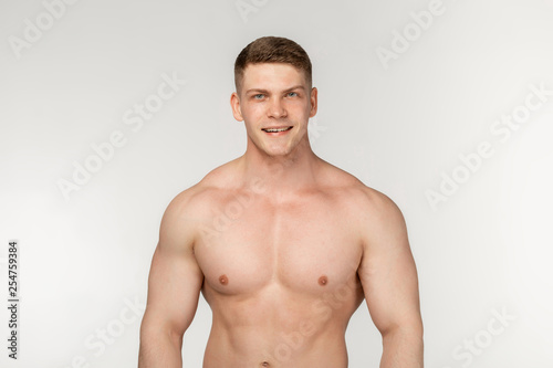 Half length portrait of shirtless muscular healthy man