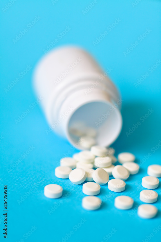 Assorted pharmaceutical medicine pills, tablets and capsules and bottle on blue background. Drugs and various narcotic substances. Copy space for text. Stock photo for design Assorted pharmaceutical medicine pills, tablets and capsules and bottle on blue background. Drugs and various narcotic substances. Copy space for text. Stock photo for design