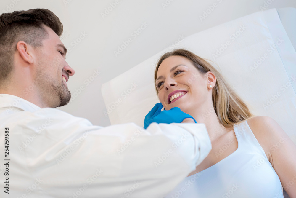 Young doctor doing skin treatment with hyaluronic acid injections on the face of young woman Young doctor doing skin treatment with hyaluronic acid injections on the face of young woman