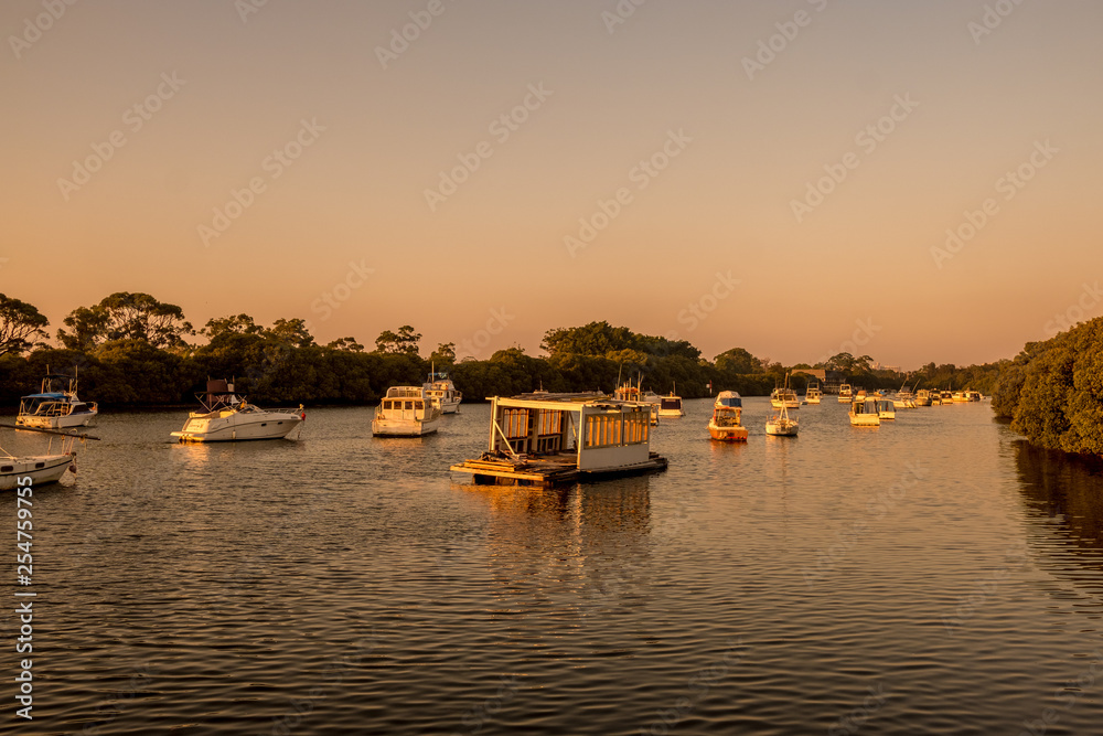 sunrise on a river with boats