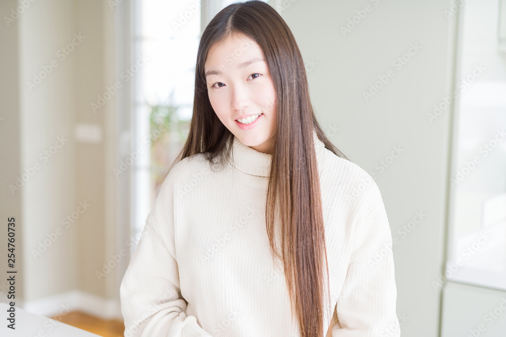 Beautiful Asian woman wearing casual sweater with a happy and cool smile on face. Lucky person. Beautiful Asian woman wearing casual sweater with a happy and cool smile on face. Lucky person.