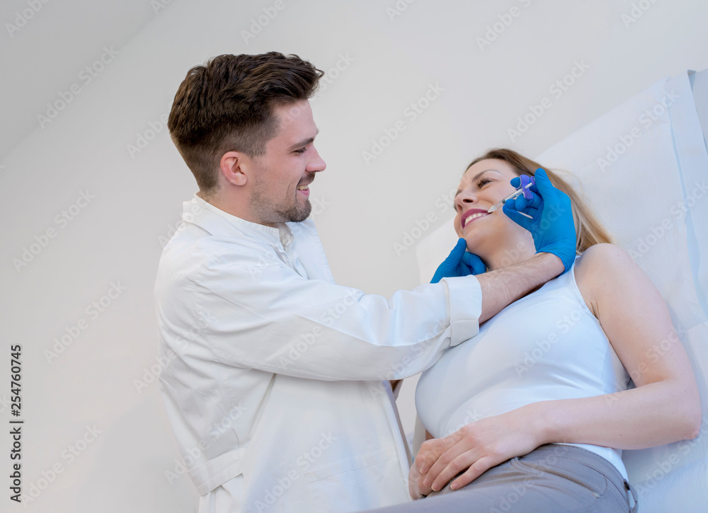 Doctor doing hyaluronic acid injections on the face of young woman in a beauty clinic Doctor doing hyaluronic acid injections on the face of young woman in a beauty clinic
