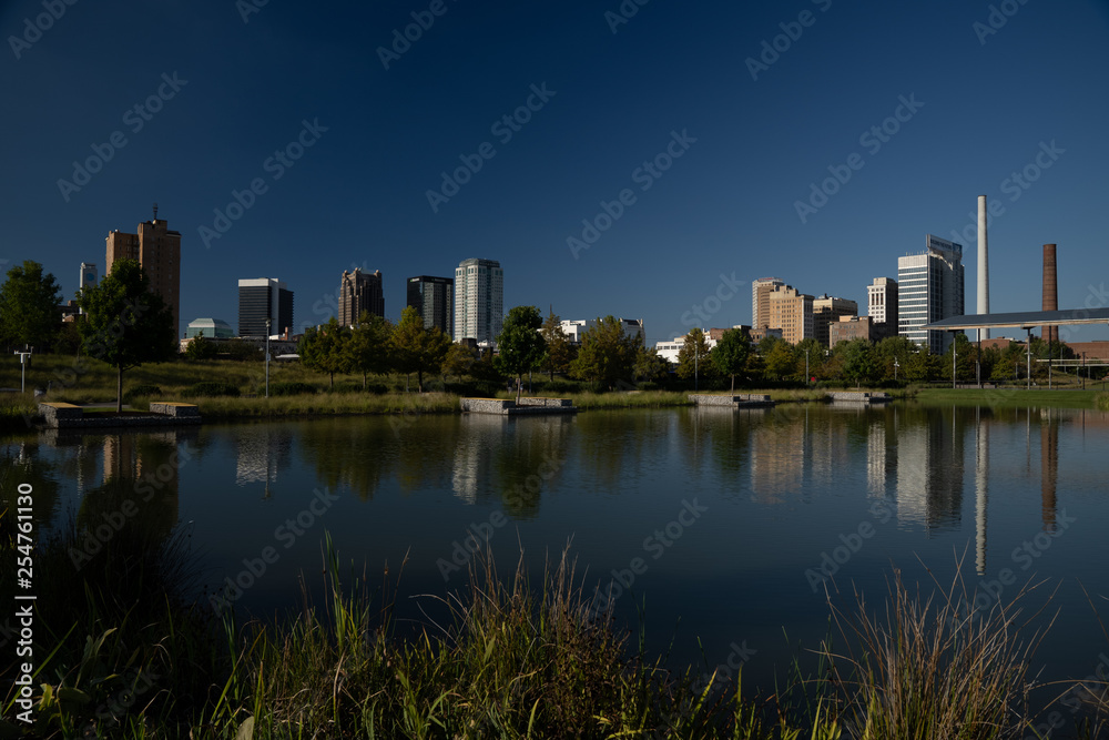 Birmingham, Alabama skyline reflects on a pond in Railroad Park