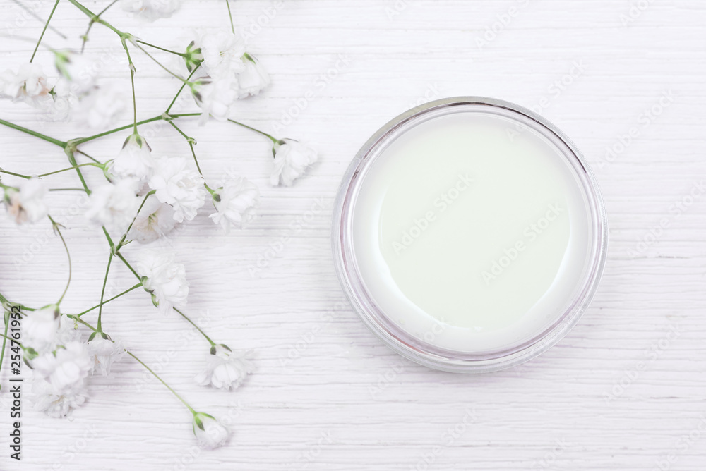 Cosmetic natural cream in a jar on a white table background. Cosmetic natural cream in a jar on a white table background.