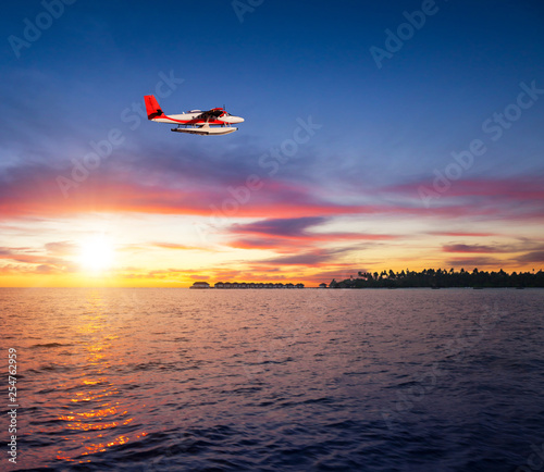 Beautiful sunset on Maldives resort with seaplane