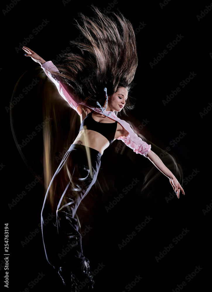 one caucasian young woman modern  dancer dancing isolated on black background with  light painting motion blur speed effect