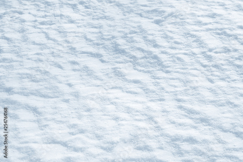 Fresh snow background texture. Winter background with snowflakes and snow mounds. Snow lumps.