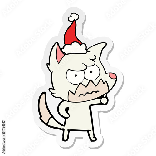 sticker cartoon of a annoyed fox wearing santa hat