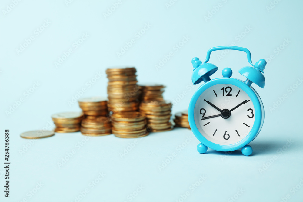 Time is money concept. Alarm clock and golden coins. Financial option of cash investment. Time is money concept. Alarm clock and golden coins. Financial option of cash investment.