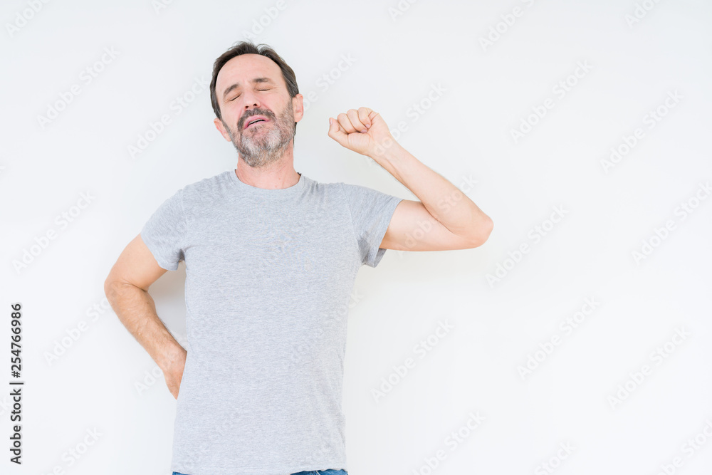 Handsome senior man over isolated background stretching back, tired and relaxed, sleepy and yawning for early morning Handsome senior man over isolated background stretching back, tired and relaxed, sleepy and yawning for early morning