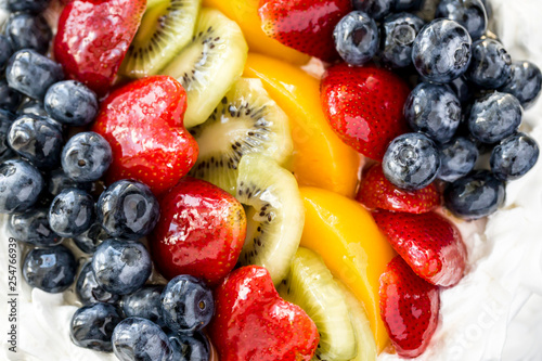 Overview of glazed fruit on a cake.