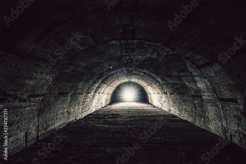 Light in end concept. Underground concrete tunnel or corridor of abandoned nuclear bunker or shelter or basement
