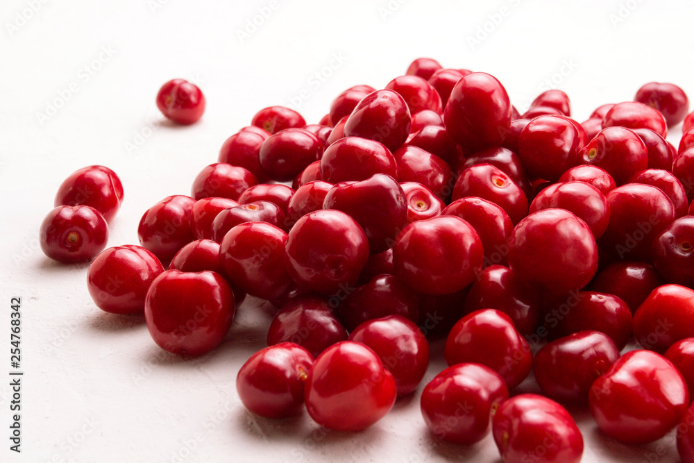 Fresh cherry on a light stone background. Concept of harvest Fresh cherry on a light stone background. Concept of harvest