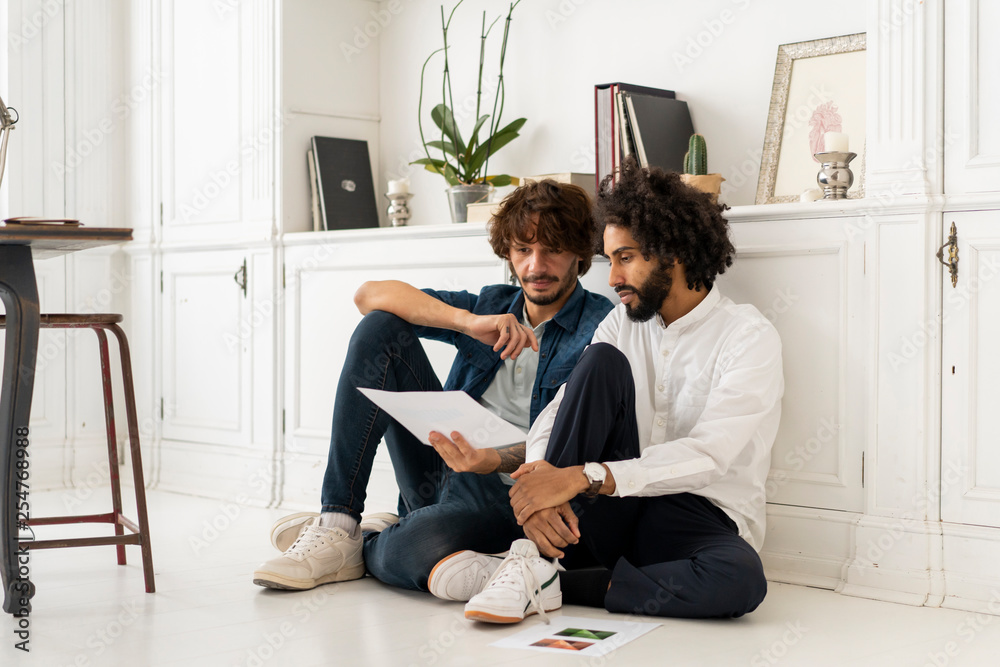 Business people discussing over document in office