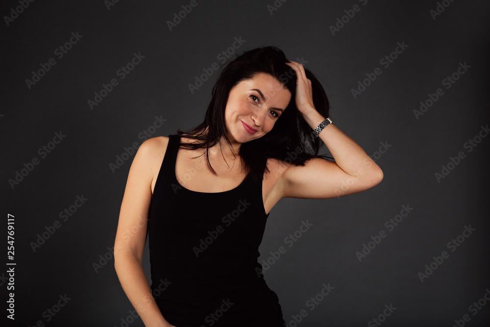 Natural beauty concept. Sexy body of young attractive woman. Beautiful sporty lady in black top and blue jeans Natural beauty concept. Sexy body of young attractive woman. Beautiful sporty lady in black top and blue jeans