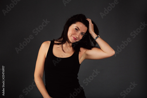 Natural beauty concept. Sexy body of young attractive woman. Beautiful sporty lady in black top and blue jeans