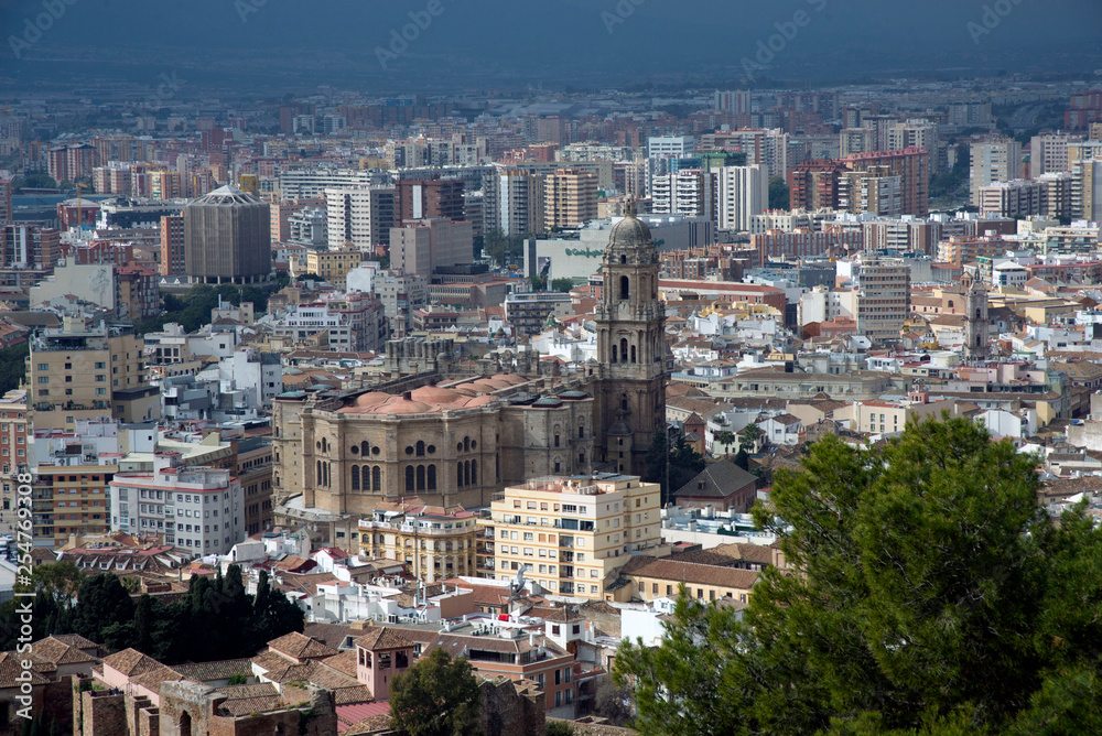 Malaga, Spain, February 2019. Panorama of the Spanish city of Malaga. Buildings  against a cloudy sky. Dramatic sky over the city. Beautiful view.