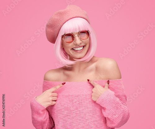 Smiling woman pointing at herself
