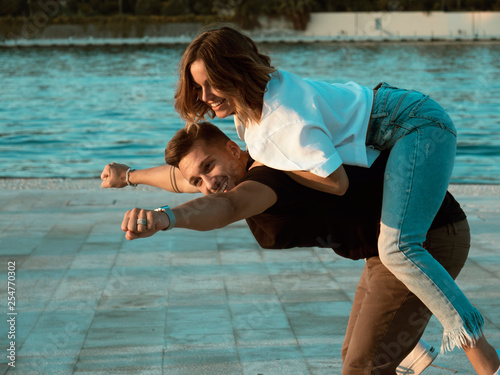 Man giving piggyback ride to girlfriend, having fun