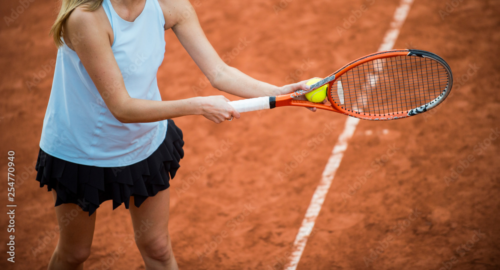 A tennis player prepares to serve a tennis ball during a match