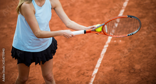 A tennis player prepares to serve a tennis ball during a match © Augustas Cetkauskas