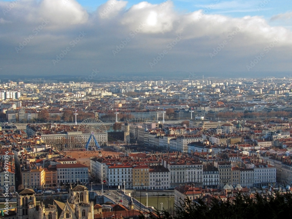 Aerial view of a cityscape of downtown Lyon in France with plenty of red roofs and white old buildings