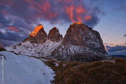 Italy, Alto Adige, Dolomites, Sassolungo, Fuenffingerspitze and Grohmannspitze at sunrise twilight, late autumn with first snow photo