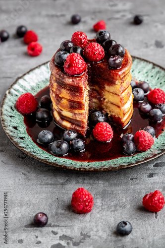 Pancakes with blueberries, raspberries and black currant syrup