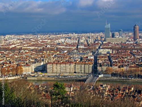 Aerial view of the city wide panorama with landmarks surrounded by red rooftops and chimneys  Lyon  France