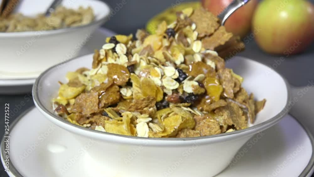 Taking a spoonful of muesli breakfast cereal Taking a spoonful of muesli breakfast cereal