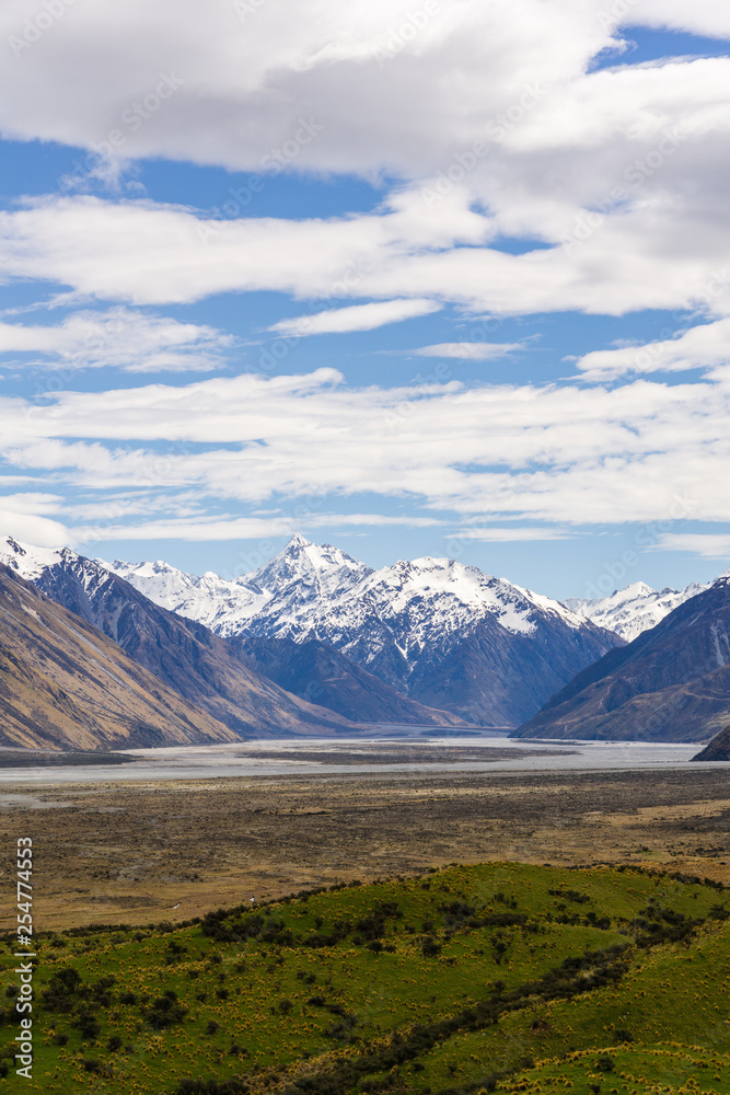 Beautiful vast valley with mountains on the horizon, mountain peak covered by snow, during sunny with dramatic sky, mountain landscape Beautiful vast valley with mountains on the horizon, mountain peak covered by snow, during sunny with dramatic sky, mountain landscape