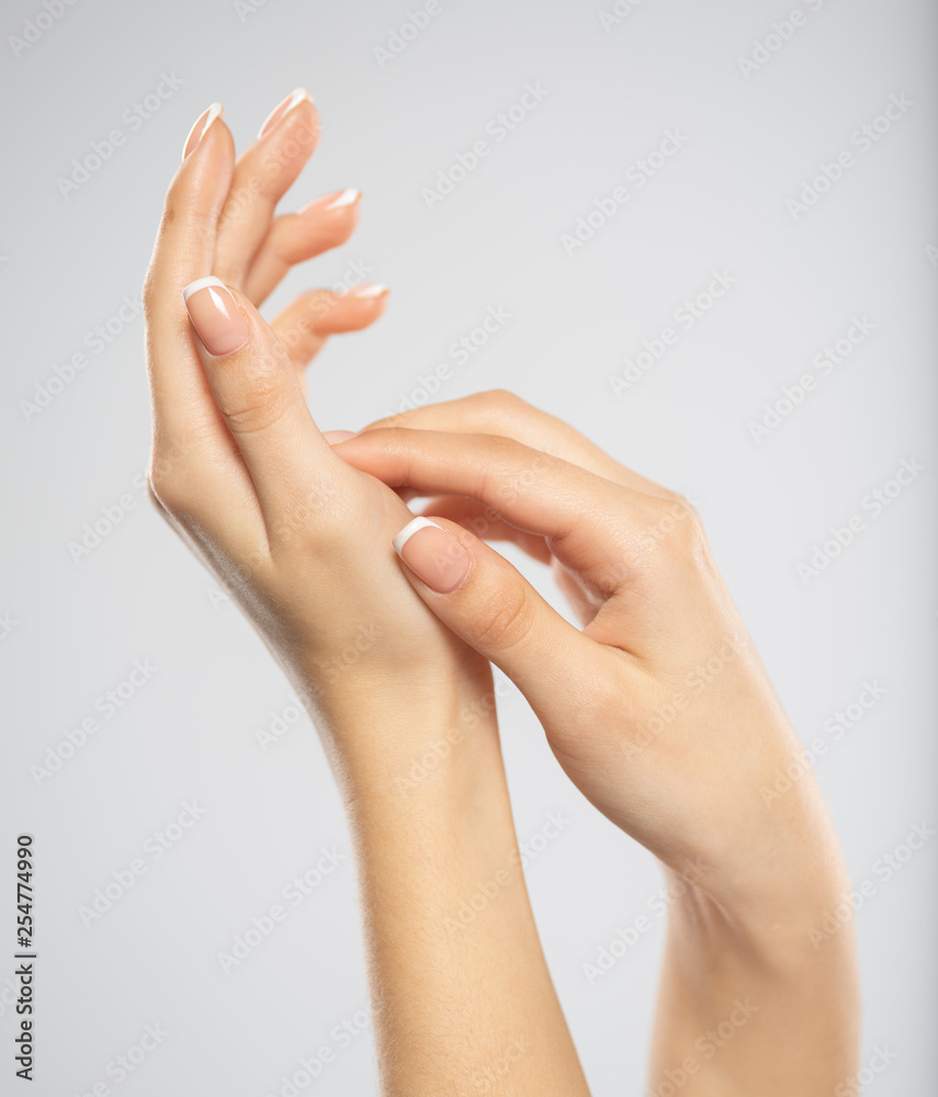 Woman gets manicure procedure in a spa salon. Beautiful female hands. Woman gets manicure procedure in a spa salon. Beautiful female hands.