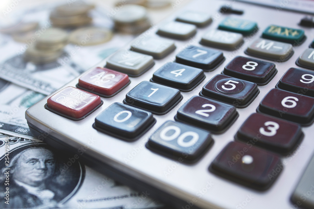 Calculator with dollars and coins on wooden background. Calculator with dollars and coins on wooden background.