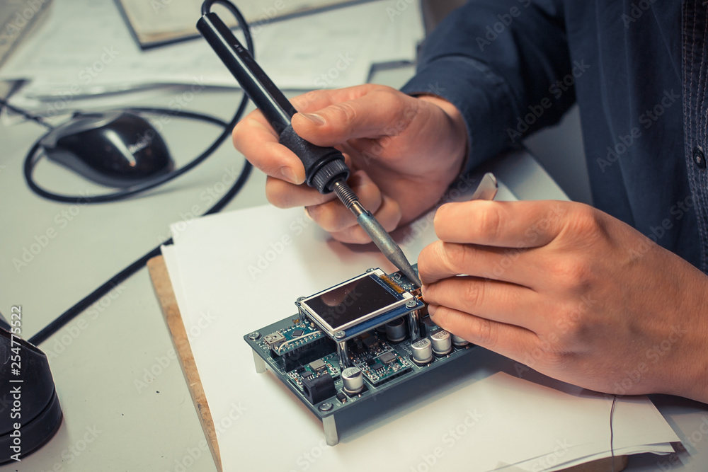 a man soldering device board with integrated circuit a man soldering device board with integrated circuit