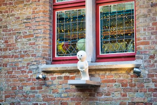 BRUGES, BELGIUM - FEBRUARY 17, 2019: a boy peeing on a house