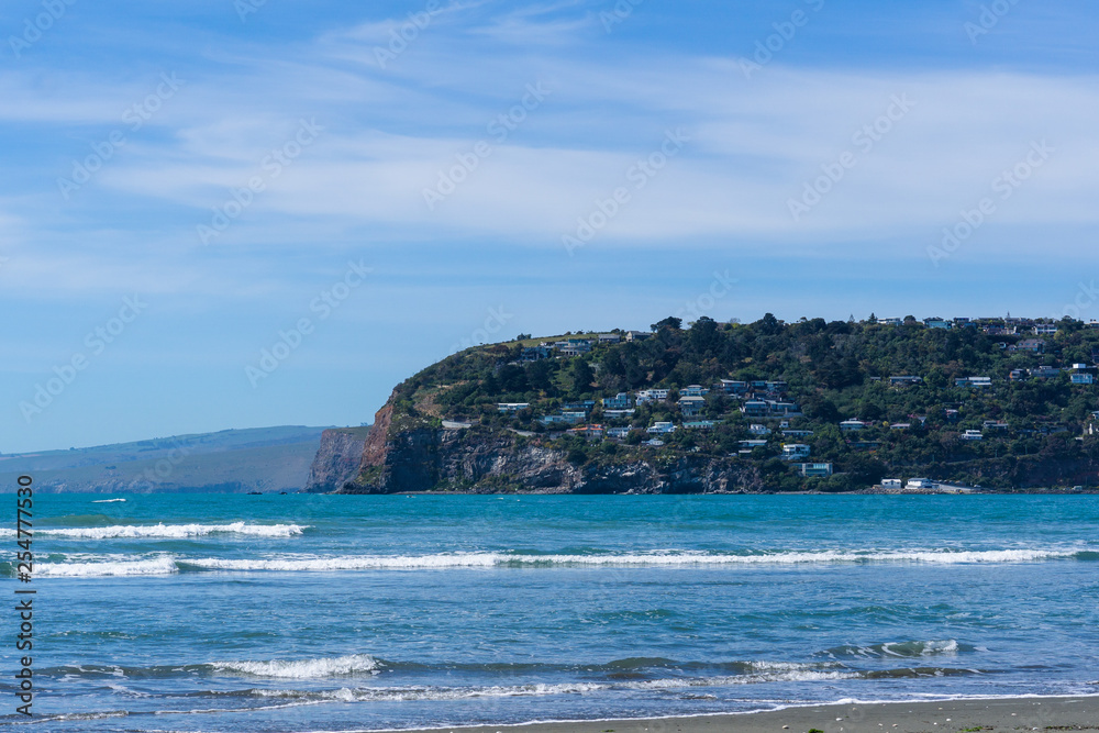 Coastline during sunny day, blue calm sea